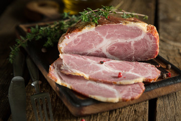 A piece of smoked meat with herbs