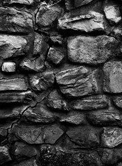 Old monastery wall made of big rocks b&w vertical 3d texture, background