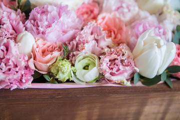 a bunch of fresh beautiful flowers in a brown wooden box