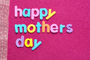 Fototapeta na wymiar Happy mothers day on a pink background with a pink ribbon