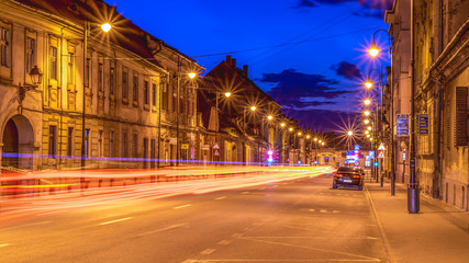 Fototapeta na wymiar Beautiful night street at sunset in Sibiu, Romania