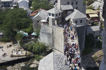 Fototapeta na wymiar View from the top of the historic Mostar bridge full of people