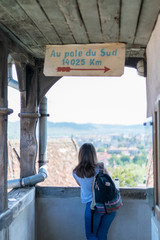 A girl admiring the view from Sighisoara Clock Tower on a sunny day.