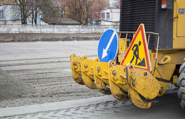 Men at work, asphalt laying. Road-building. Road construction machinery. Road grader