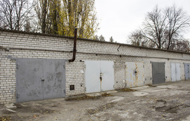 Old abandoned garages with gray metal gates