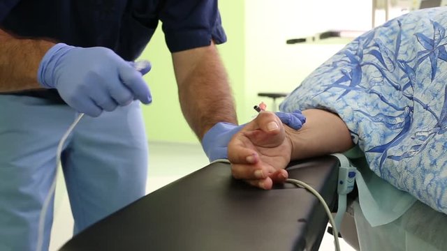 the doctor puts the dropper in the patient's hand