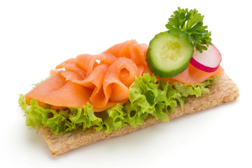 Bread with fresh salmon fillet isolated on white background, top view.