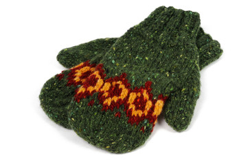 Fototapeta premium Green handmade mittens on a white background. View from above.