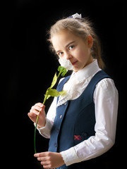 Little girl with a flower in her hand.