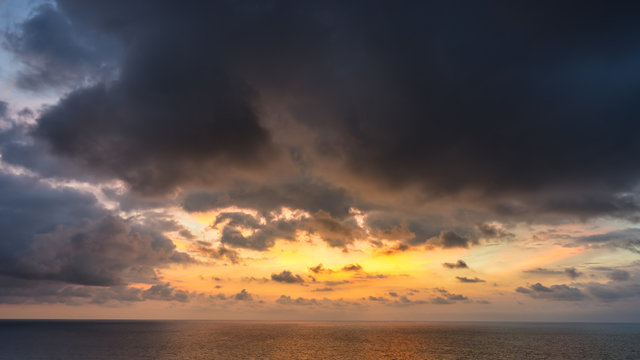 Colorful sunset cloudscape over the ocean horizon