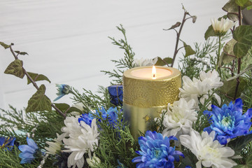 Bouquet of roses, ivy, juniper and candle. Chrysanthemums and candle, Christmas composition