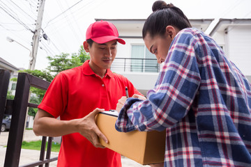 Woman accepting a delivery of boxes from delivery service courier. Isolated on a White Background.