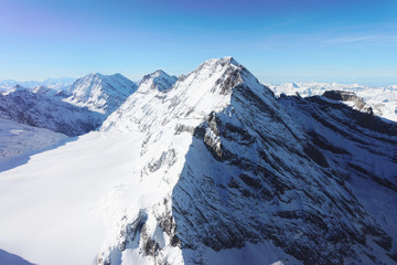 Fototapeta na wymiar Jungfrau Mountain peak at winter Swiss Alps
