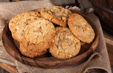 Pile of peanut butter cookies on a wooden plate