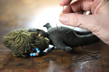 vintage voodoo doll on wooden background