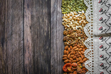 pumpkin seeds, cashew, walnut, almonds, on a wooden background, pattern, fabric, dried fruits, background texture, view svrhu, benefits, vitamins, still life beautiful, flat lay