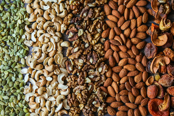 pumpkin seeds, cashew, walnut, almonds, on a wooden background, background texture, view svrhu, benefits, vitamins, still life beautiful, healthy lifestyle, diet, charge for the brain, flat lay