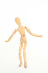 The wooden mannequin steps uncertainly. On a white background.