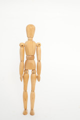 The wooden dummy stands straight. On a white background.