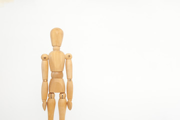 The wooden dummy stands straight. On a white background.