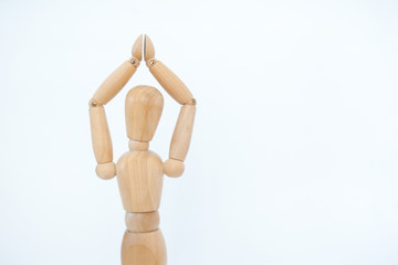 A wooden manicure performs exercises of gymnastics. On a white background.