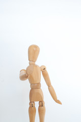 A wooden dummy shows a stop. On a white background.