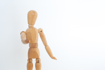 A wooden dummy shows a stop. On a white background.