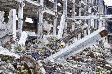 Remains of the destroyed industrial building. The skeleton of a large building of concrete beams,