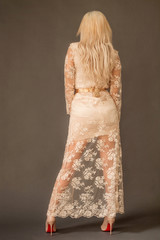 Blonde woman back portrait, wearing white lace dress