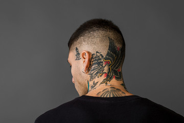 Tattooed man back portrait - Eagle, ship, swallow and dagger tattoos