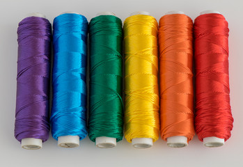 Rainbow flag. LGTB symbol made with colorful spools of thread.