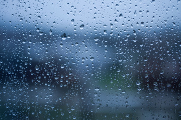 Naklejka na ściany i meble The texture of rain drops on the glass from the shower