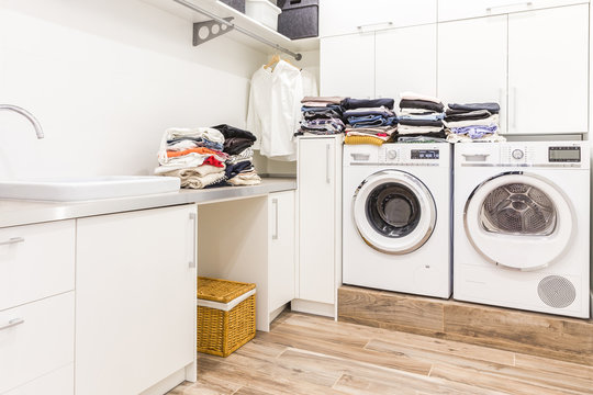 Stacks Of Clean Clothes In Laundry Room