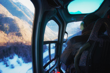 Fototapeta premium Man at cabin of helicopter Swiss Alpine heliport