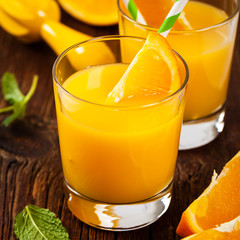 Orange Juice on wooden background. Selective focus.