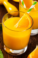 Orange Juice on wooden background. Selective focus.