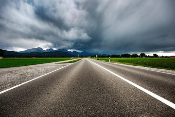 Road leading into a storm - Forggensee and Schwangau, Germany Bavaria