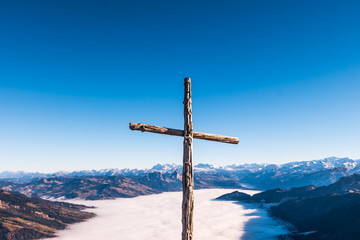 Christian cross over the top of mountain range