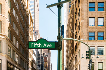 New york city fifth avenue signpost with old building