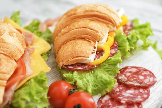 Plate with delicious croissant sandwich, closeup