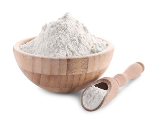 Fototapeta na wymiar Bowl and scoop of wheat flour on white background