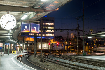 A view of train station with railway tracks in the early morning time
