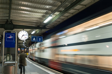 High speed electric train moving pass through train station