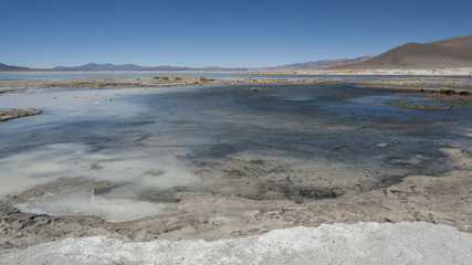 Laguna y Termas de Polques hot spring pool with Salar de Chalviri in background, Salar de Uyuni, Potosi, Bolivia - South America	