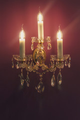 Wall lamp in classic style hanging on your wall. Interior