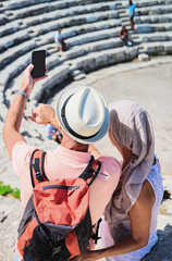 People taking photos at old theater in Segesta