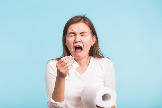 Woman Sneezing Studio Portrait Concept on blue background