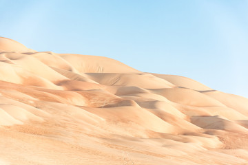 Beautiful remote sandy desert landscape of golden dunes in Liwa desert in Empty Quarter. Abu Dhabi, UAE.