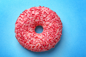 Delicious pink donut on color background - obrazy, fototapety, plakaty