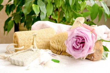 Obraz na płótnie Canvas Sea salt crystals for bathroom, pumice, luff, rose flower, body brush, shells, handmade soap with the addition of sand for heels